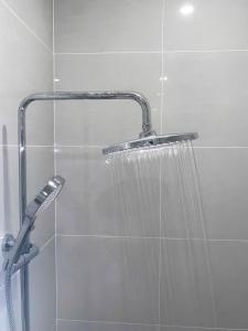 a shower with a shower head in a bathroom at Luxury Hotel Long Thành in Xóm Nước Trong