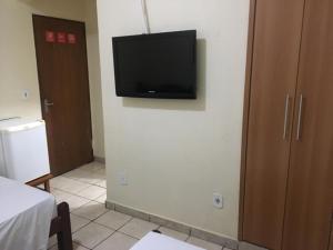 a flat screen tv on a wall in a room at HOTEL CENTER Ribeirão in Ribeirão Preto +15 photos