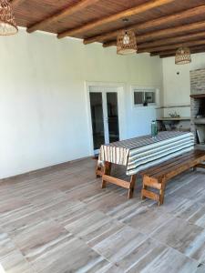a living room with a wooden table and a bench at El Chiringuito in Paraná