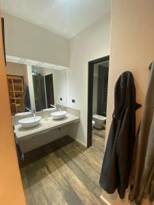 a bathroom with two sinks and a mirror at Casa Quinta in Córdoba +7 photos