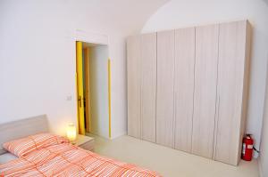 a bedroom with a bed and a large closet at Sciù Sciù House in Atrani