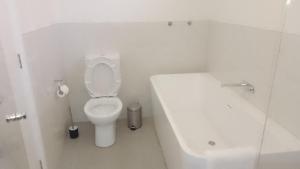 a white bathroom with a toilet and a sink at The Piddington Top in Mount Victoria +15 photos