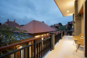a balcony with a view of the roofs of houses at Sleepwell Seminyak in Seminyak