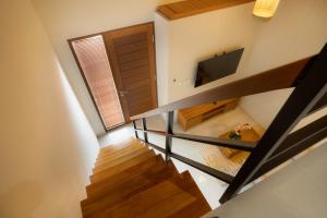 an overhead view of a staircase with a television at Sleepwell Seminyak in Seminyak