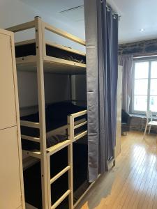 a bedroom with bunk beds in a room at Alt Hostel in Montreal
