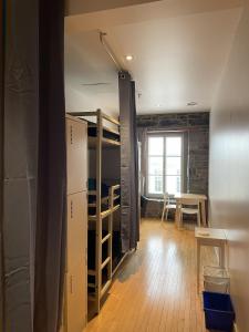 a dorm room with bunk beds and a table at Alt Hostel in Montreal