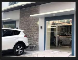 a white car parked in front of a building at Rana Hotel in Sampong