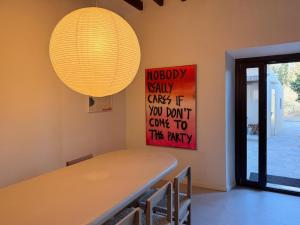 a dining room table with a light hanging above it at Manyolas 93 in Alaró +9 photos