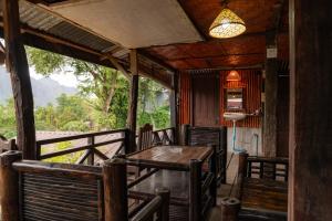a dining room with a table and chairs at Vang Vieng Ban Lao Guesthouse in Vang Vieng