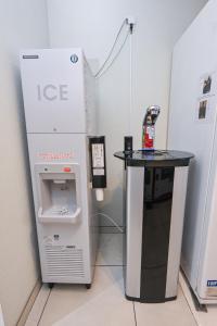 a room with a ice machine and a table at La'gent Hotel Osaka Bay in Osaka