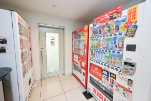 a room with a vending machine and posters on the wall at La'gent Hotel Osaka Bay in Osaka +41 photos