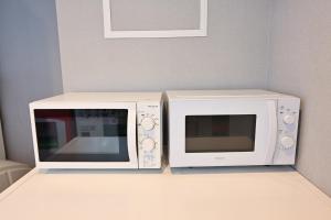 two microwaves sitting on a counter next to each other at La'gent Hotel Osaka Bay in Osaka