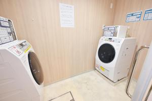 a washing machine and a washer in a room at La'gent Hotel Osaka Bay in Osaka