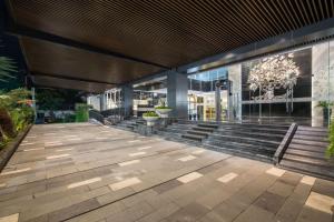 a lobby of a building with stairs and a building at Grand Swiss-Belhotel Darmo in Surabaya