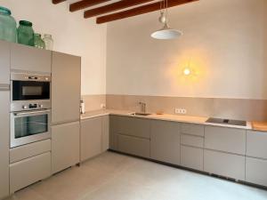 a large kitchen with white cabinets and appliances at Manyolas 93 in Alaró