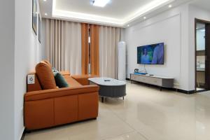 a living room with a couch and a tv at WeChat user-s store in Gongche