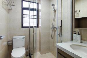 a bathroom with a shower and a toilet and a sink at WeChat user-s store in Gongche