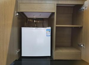 a small refrigerator in a kitchen with a cabinet at Luke Cloud CTSE-s store in Gangkou +12 photos