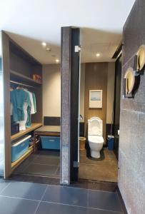 a bathroom with a toilet and a sink at Luke Cloud CTSE-s store in Gangkou
