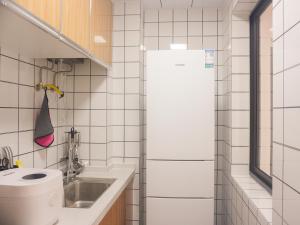 a small bathroom with a toilet and a sink at Luke Cloud 4G6Y store in Gongche +49 photos