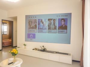 a large screen with pictures on a wall in a room at Luke Cloud 4G6Y store in Gongche