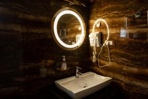 a bathroom with a sink and a mirror at Hills Pride in Nandi