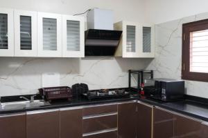 a kitchen with a sink and a microwave at Hills Pride in Nandi