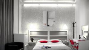 a bedroom with a white bed and white walls at Hotel Palermo in Barcelona