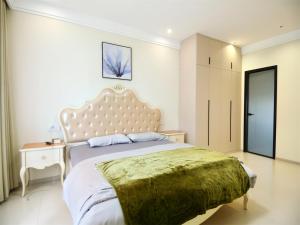 a bedroom with a large bed with a green blanket at Luke Cloud GSHT Store in Luoyang