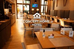 a restaurant with tables and chairs and a sign that reads concept home hotel at Astron Mundial luxo Concept in Salvador