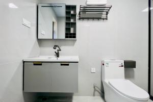 a bathroom with a toilet and a sink and a mirror at Luke Cloud MVHG-s store in Gongche +27 photos