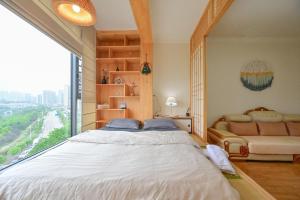 a bedroom with a large bed and a large window at Xia Jiming-s store in Ganzhou