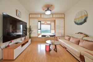 a living room with a couch and a large television at Xia Jiming-s store in Ganzhou