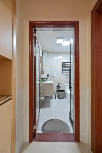 a bathroom with a door open to a bathroom with a sink at Xia Jiming-s store in Ganzhou +42 photos