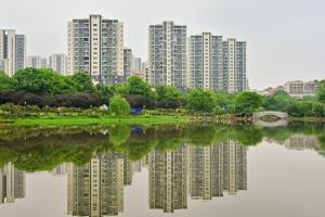 a city with tall apartment buildings and a lake at Xia Jiming-s store in Ganzhou