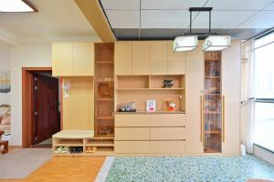 a room with white cabinets and a large window at Xia Jiming-s store in Ganzhou