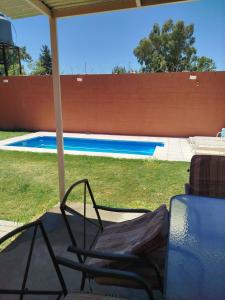 a chair under an umbrella next to a swimming pool at mary in San Luis +26 photos