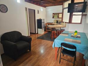 a living room with a table and a chair at Apartamento 2 TEC in Cartago