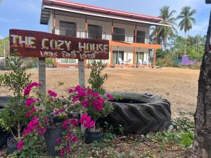a sign in front of a house with flowers at The cozy house in Trang +3 photos