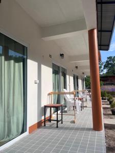 a porch with chairs and tables on a house at The cozy house in Trang