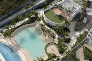 an overhead view of a swimming pool with palm trees at Azure Luxe Haven by Irene in San Fernando