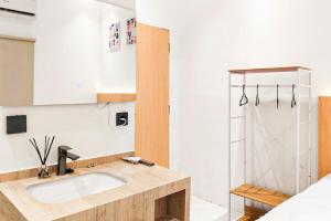 a bathroom with a sink and a shower at Adi Inn Homestay RedPartner in Sunggal