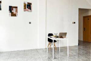 a white table with a laptop on it in a room at Adi Inn Homestay RedPartner in Sunggal +31 photos