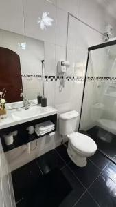 a bathroom with a toilet and a sink at Loft São Roque U01 Rota do Vinho em São Roque SP in São Roque