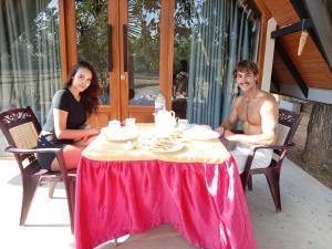 a man and a woman sitting at a table at Sunset Dream Cabana in Tangalle