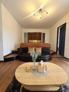 a living room with a couch and a table at Mondara Villa and Glamping in Ban Bo Wi