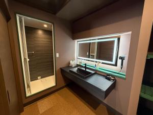 a bathroom with a sink and a mirror at Lento Stay HAGI in Hagi +41 photos
