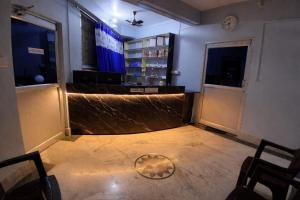 a room with a bar with a soccer ball on the floor at Bhakta Bhawan in mayapur