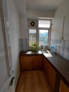 a kitchen with a counter top and a window at Indu Homestay in Shimla