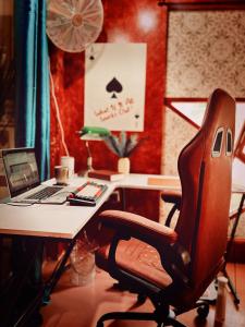 an office with a desk with a chair and a laptop at Alter Space Workspace and CoLiving in General Luna